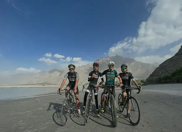 Baltistan Cycling Club riders beneath the Karakoram peaks